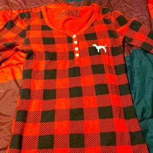 Long sleeve pink shirt. Red and black checkered pattern. Gently used.